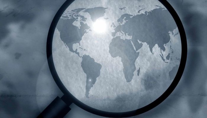 Vintage world map with magnifying glass